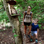 mother and son look at fairy house